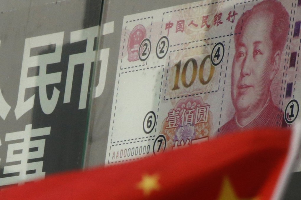 China's national flag is seen in front of a poster explaining the design of new 100 yuan banknote at a branch of a commercial bank at a business district in Beijing, China. Photo: Reuters