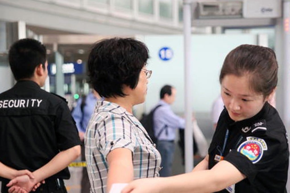 A passenger passes through an airport security check in China. Photo: SCMP Pictures