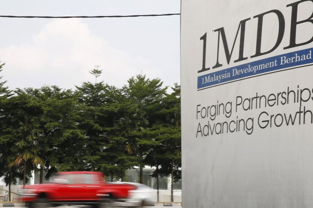 Traffic passes a 1Malaysia Development Berhad (1MDB) billboard at the Tun Razak Exchange development in Kuala Lumpur, Malaysia. The state investment fund has been mired in controversy. Photo: Reuters
