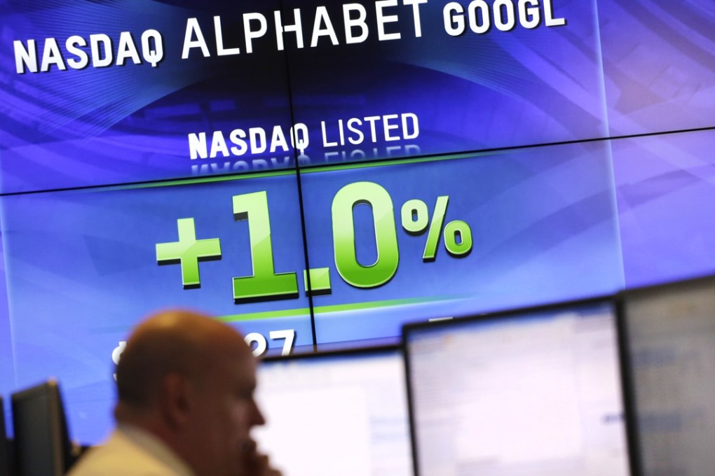 Electronic screens post the price of Alphabet stock on February 1 at the Nasdaq MarketSite in New York. Alphabet’s stock price saw it valued at US$530.1 billion at close of trade yesterday - compared to $534.7 billion for Apple - but price of Google’s parent kept rising in after-hours trading. Photo: AFP