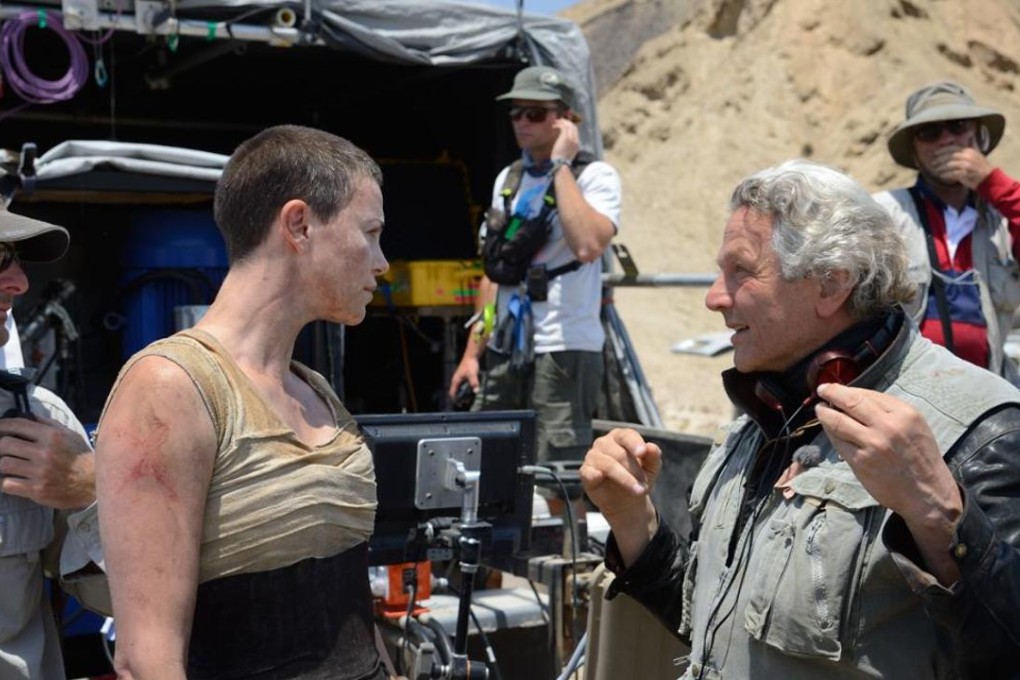George Miller (right) gives Charlize Theron direction on the set of Mad Max: Fury Road.