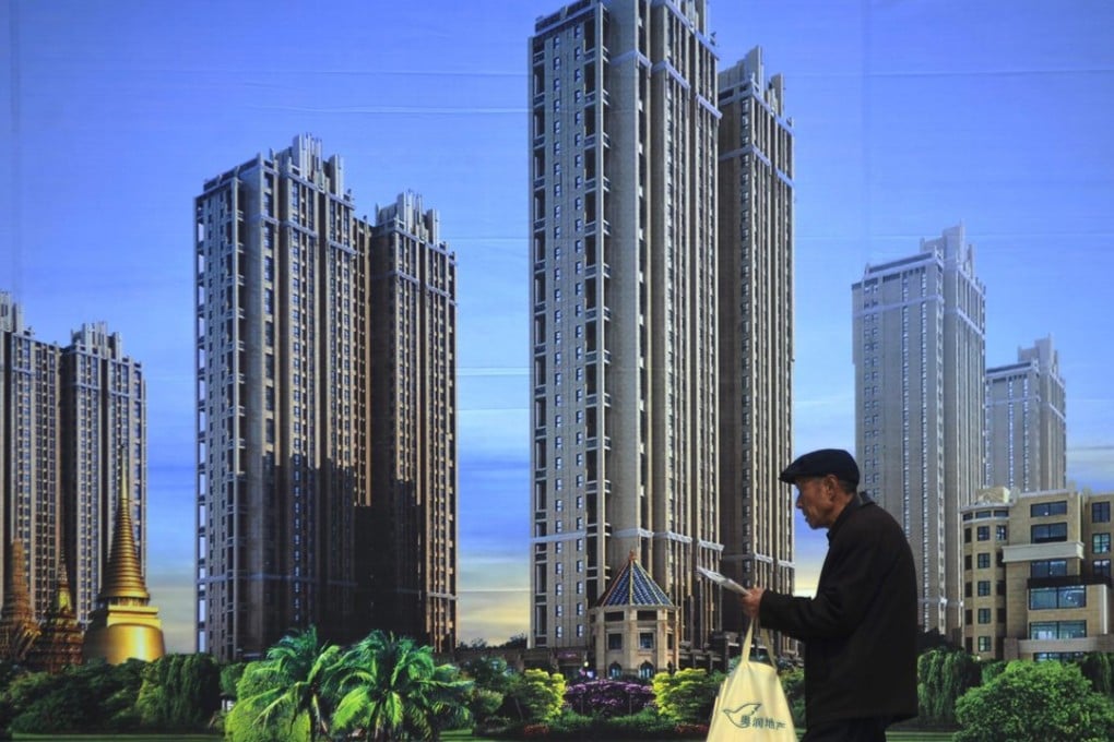 An elderly consumer passes by a large real estate poster at a real estate fair in Qingdao city, in eastern China's Shandong province. Photo: EPA