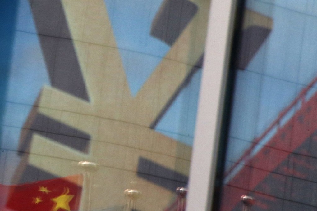 The Chinese flag is reflected on a commercial bank advertisement in Beijing. Photo: Reuters
