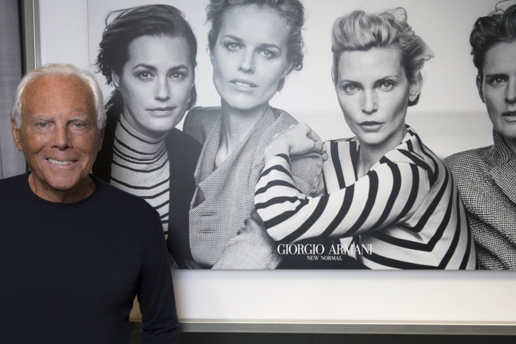 Fashion designer Giorgio Armani in front of a poster of ex-supermodels in his New Normal campaign (from left) Yasmin Le Bon, Eva Herzigova, Nadja Auermann and Stella Tennant.
