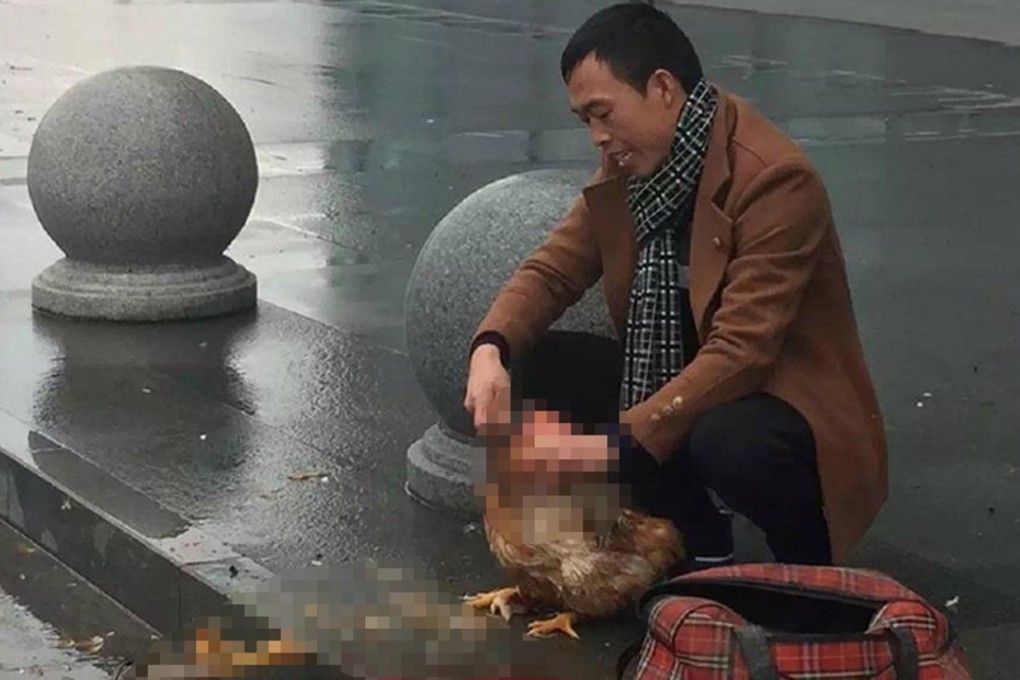 The man killing a chicken outside Wenzhou railway station. Photo: SCMP Pictures