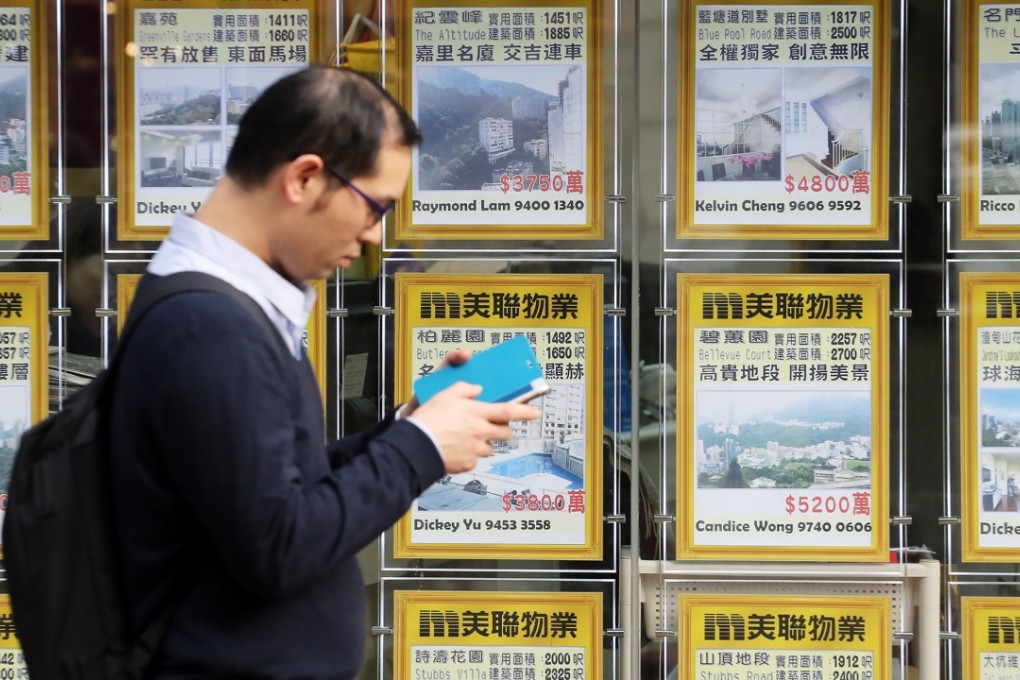 Property agent in the prime Happy Valley area of Hong Kong as sales in the city sank to their lowest in two decades. Photo: Felix Wong