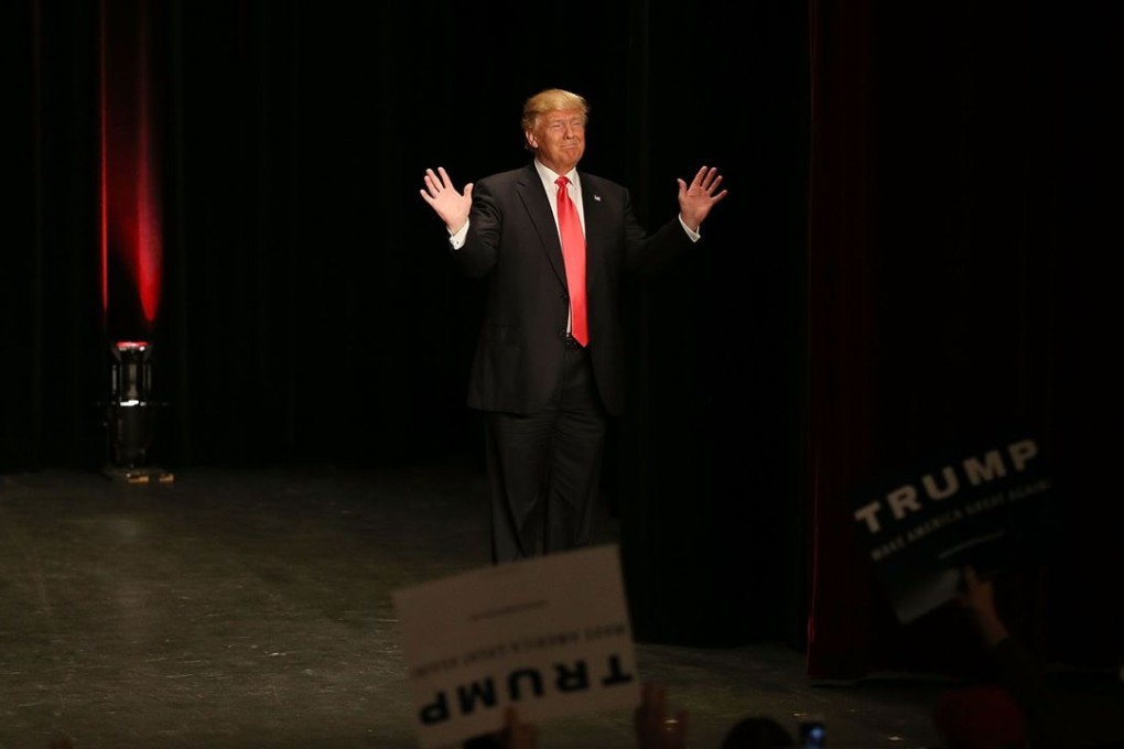 Republican presidential candidate Donald Trump, a narcissistic business executive, arrives on stage for a campaign rally in Sioux City, Iowa, on Sunday. Photo: AFP