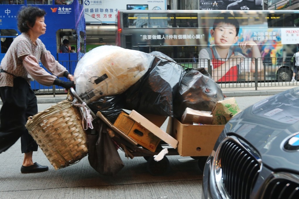 A woman pushes a trolley full of cardboard and plastic in Wan Chai. The wealthiest 1 per cent in Hong Kong own 52.6 per cent of the city’s wealth. Photo: Sam Tsang