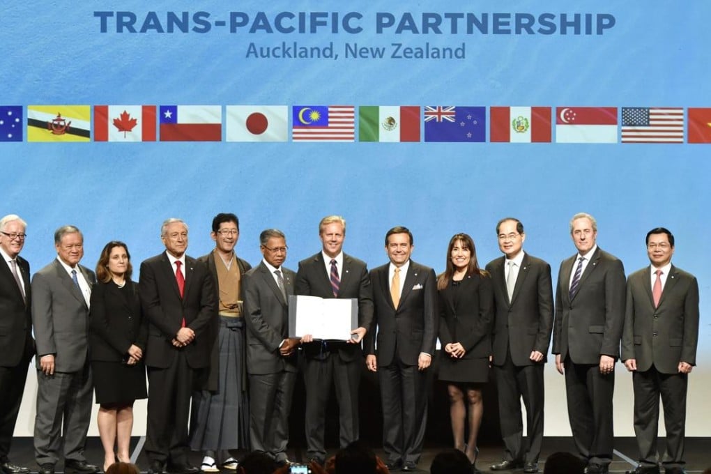 Officials from signatory countries of the Trans-Pacific Partnership accord pose for a photo in a signing ceremony for the free trade deal in Auckland, New Zealand, on Thursday. Photo: Kyodo