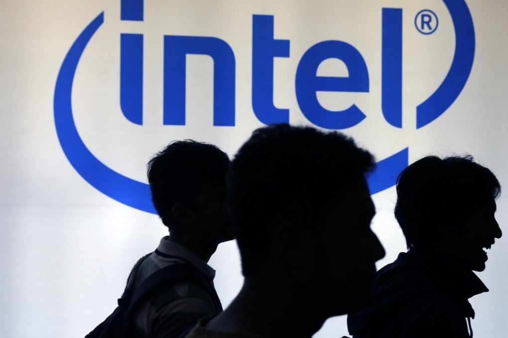 Indonesian youths walk past an Intel sign at a digital imaging expo in Jakarta. Photo: Reuters