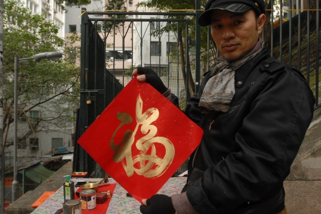 Calligrapher Derek Chan with his fai chun. Photo: Daniel Moss