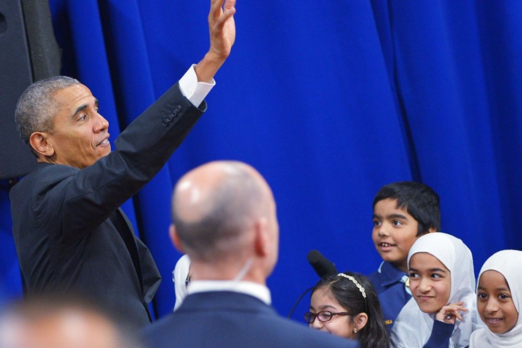 US President Barack Obama waves after greeting attendees in an overflow room at the Islamic Society of Baltimore, in Windsor Mill, Maryland, on Wednesday. Photo: AFP
