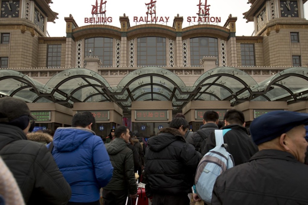 People wait in line with their luggage outside of the Beijing Railway Station for security checks, which have been tightened up ahead of this year’s Chinese Lunar New Year holiday. Photo: AP