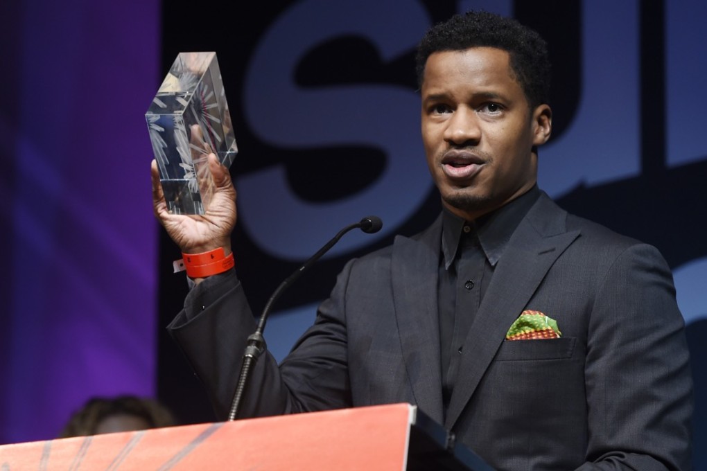 Nate Parker, the star, director and producer of The Birth of a Nation, holds up the audience award for best US dramatic film at the 2016 Sundance Film Festival awards ceremony. The film also won the audience prize for best US dramatic film. Photo: AP