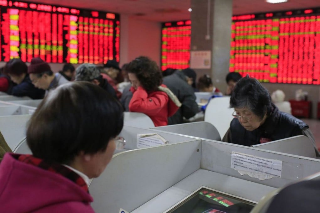 Investors look at computer screens showing stock information at a brokerage house in Shanghai. The reports by the Communist Party’s Central Commission for Discipline Inspection, covered 21 regulators and institutions. Photo: Reuters