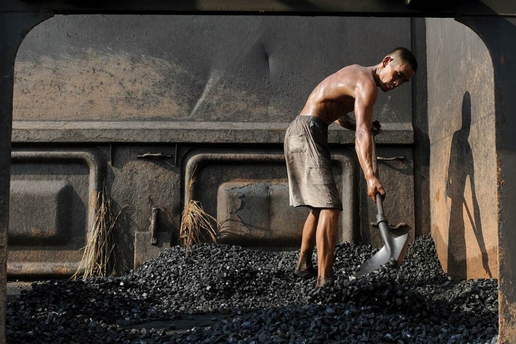 A worker unloads coal from a train in Hefei, Anhui province. Photo: AFP