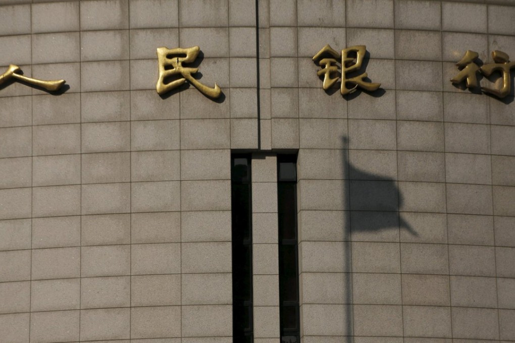 The shadow of a Chinese flag is cast on the headquarters of the People's Bank of China in Beijing. Photo: Reuters