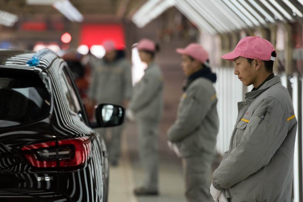 Worker stand on the production line for Kadjar cars at France’s Renault and China’s Dongfeng Group factory in Wuhan, Hubei province. Photo: AFP