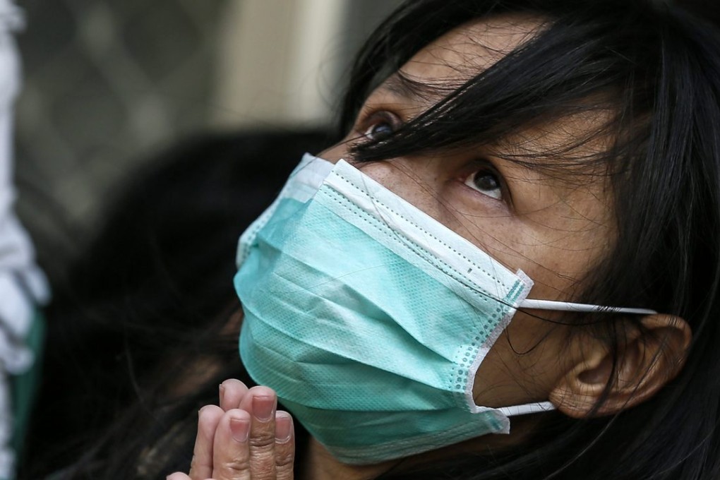 A survivor prays for the safe return of other people who are still missing after Saturday’s deadly earthquake that struck the city of Tainan in Taiwan. Photo: EPA