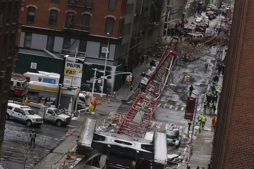 The accident happened as workers were trying to secure the crane against winds by lowering the boom. Photo: Reuters