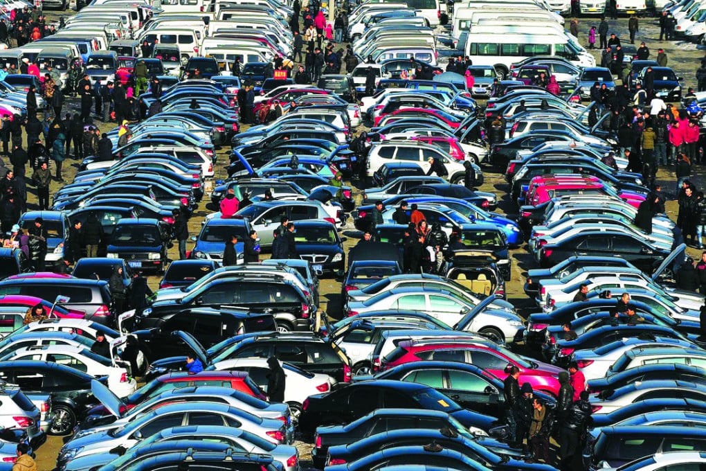 People select automobiles at a second-hand market in Shenyang, Liaoning province. China’s second-hand car market is booming. Photo: Reuters