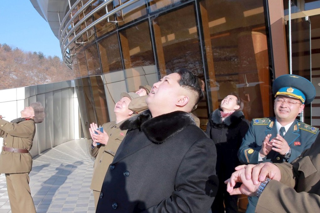 North Korean leader Kim Jong-un (C) watches a long range rocket go up, but things are going down at the UN security council which could mean sanctions for the country. Photo: Reuters/Kyodo