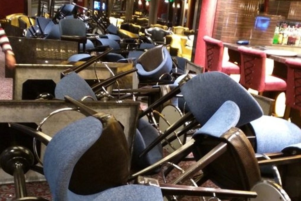 Furniture is strewn across a bar aboard the Anthem of the Seas liner, in this image shared by a passanger via social media. Photo: Twitter