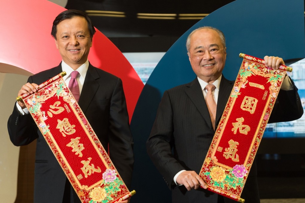 HKEx Chief Executive Charles LI Xiaojia (left) and exchange Chairman Chow Chung-kong pose for the traditional Lunar New Year photo on Friday. Photo: SCMP Pictures