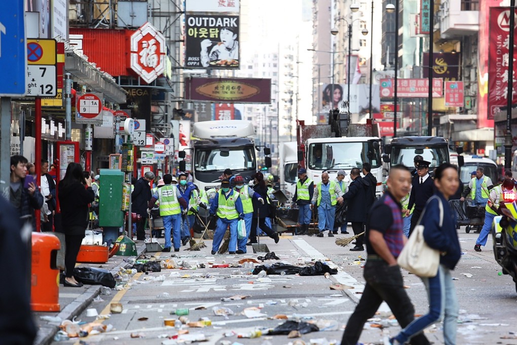 Street cleaners face the aftermath of a riot in Mong Kok. Photo: Nora Tam