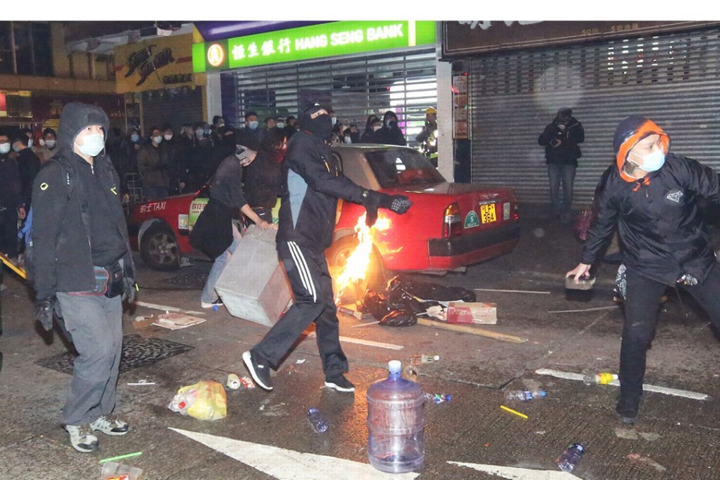 Rubbish and burnt papers are scattered on the street during the riot in Mong Kok. Photo: Edward Wong