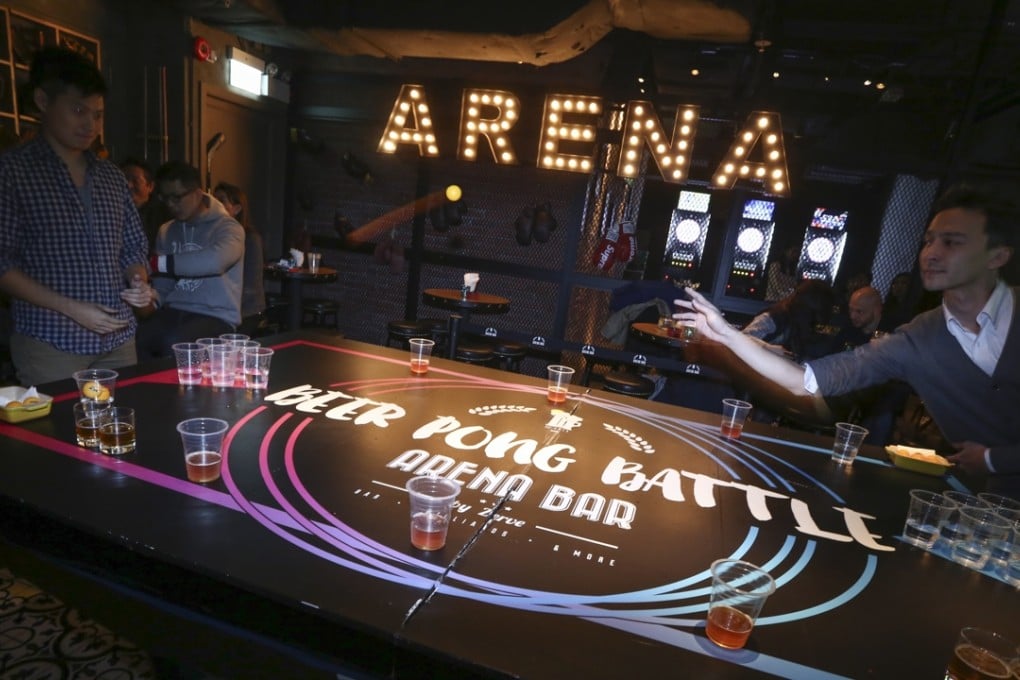 Teams play beer pong on a specially built table during the beer triathlon at Arena Bar in Tsim Sha Tsui. Photos: Jonathan Wong