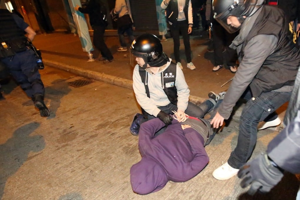 A man was arrested in the Mong Kok during clash over illegal food stalls on the night of Chinese New Year. Photo: Edward Wong
