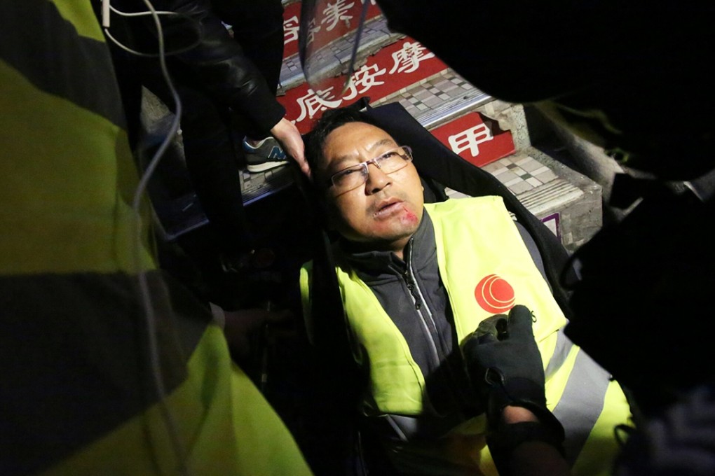 A cameraman from Cable TV was hit by a brick. Photo: Edward Wong