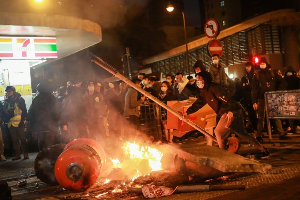 A fire burns in Mong Kok in a clash that started with a crackdown on illegal food stalls. Photo: Bloomberg