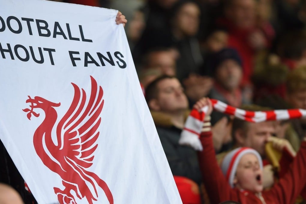 A Liverpool fan at the Premier League match between the Reds and Sunderland at Anfield holds up a banner in protest at the £77 pricing for match tickets in the newly reconstructed Main Stand. Photo: EPA