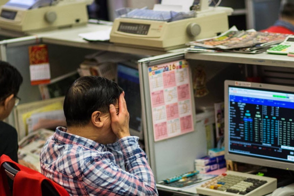 A trader reacts to changes in the markets as he works on the trading floor of the stock exchange in Hong Kong. Photo: AFP