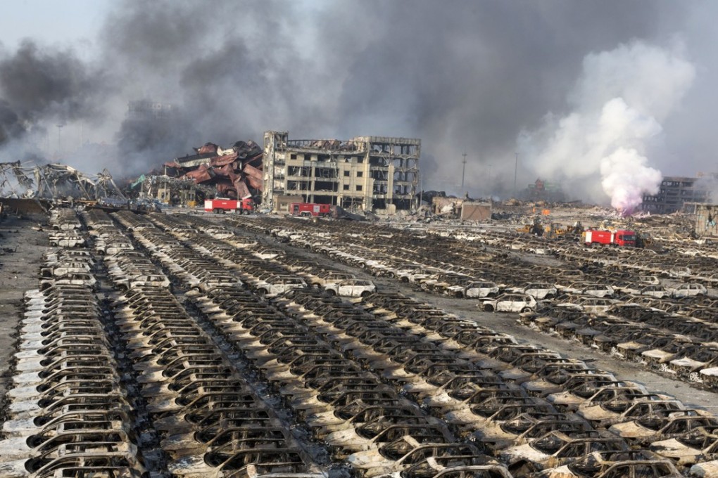 Smoke billows from the site of an explosion in August last year that reduced a Tianjin parking lot filled with new cars to charred remains. Photo: AP