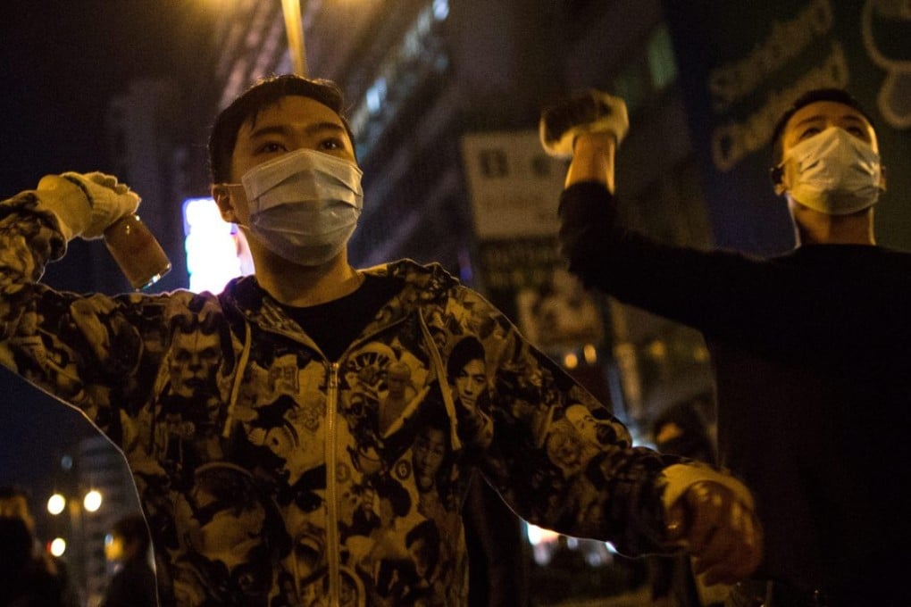 Protesters hurl objects at police officers during violent clashes in Mong Kok. Photo: EPA