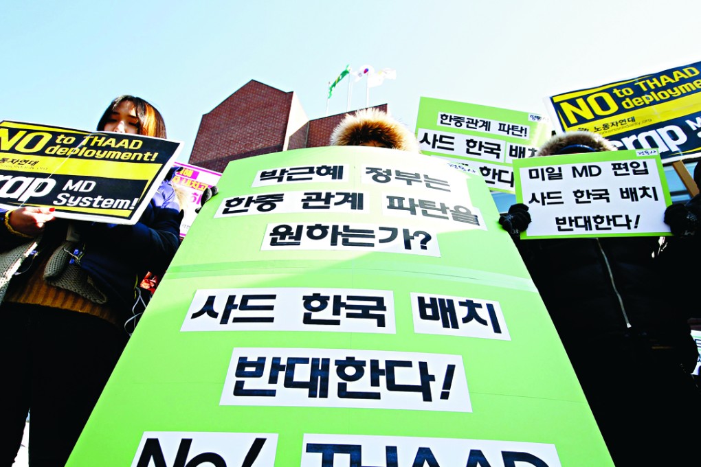 South Korean protesters shout slogans during a rally against their government's military policies near the presidential house in Seoul. Photo: EPA
