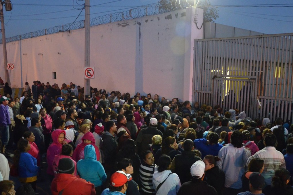 Relatives of inmates stand outside the Topo Chico prison, where a riot broke out around midnight, in Monterrey, Mexico, on Thursday. Dozens of inmates were killed. Photo: AP