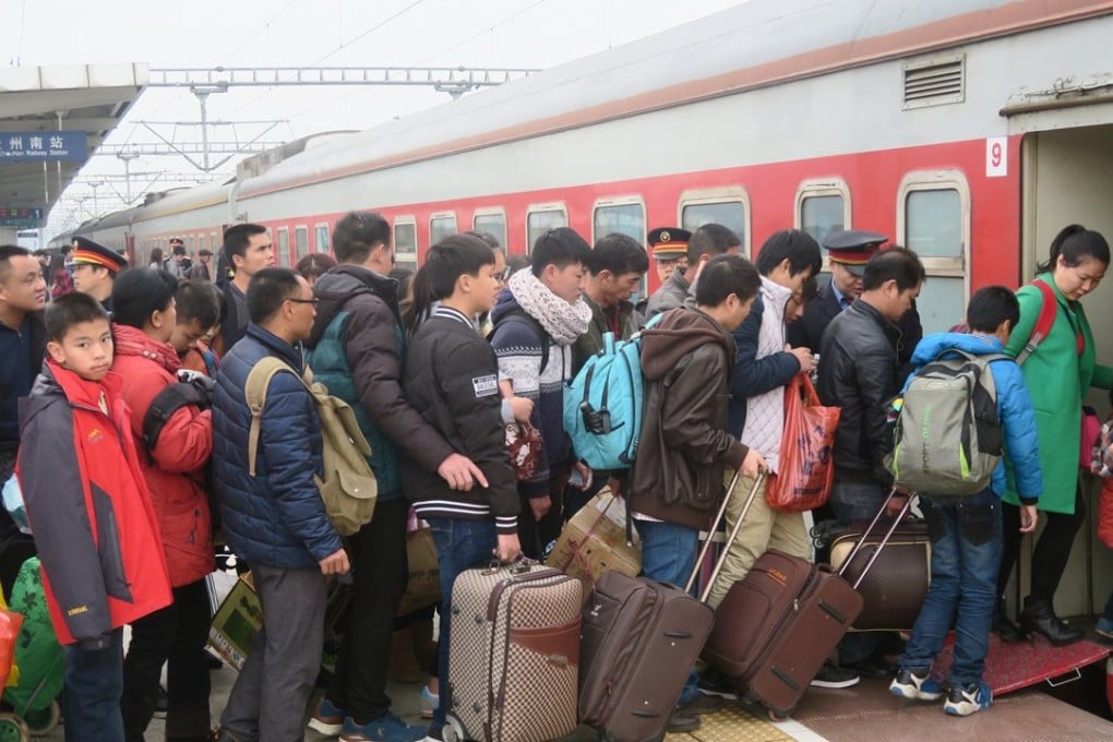 Passengers board a train during the Lunar New Year travel rush at a railway station in Guilin, Guangxi Zhuang Autonomous Region. Photo: Reuters