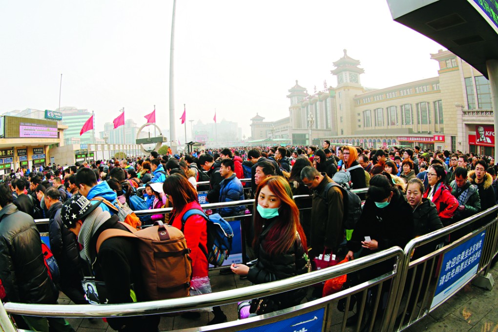 Passengers queue at Beijing Railway Station yesterday. Photo: Xinhua