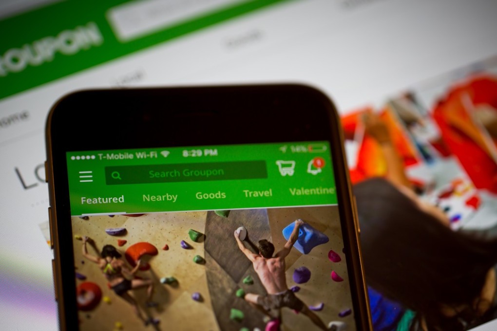 Groupon’s app is shown on an iPhone. Alibaba acquired the shares in December. Photo: Bloomberg