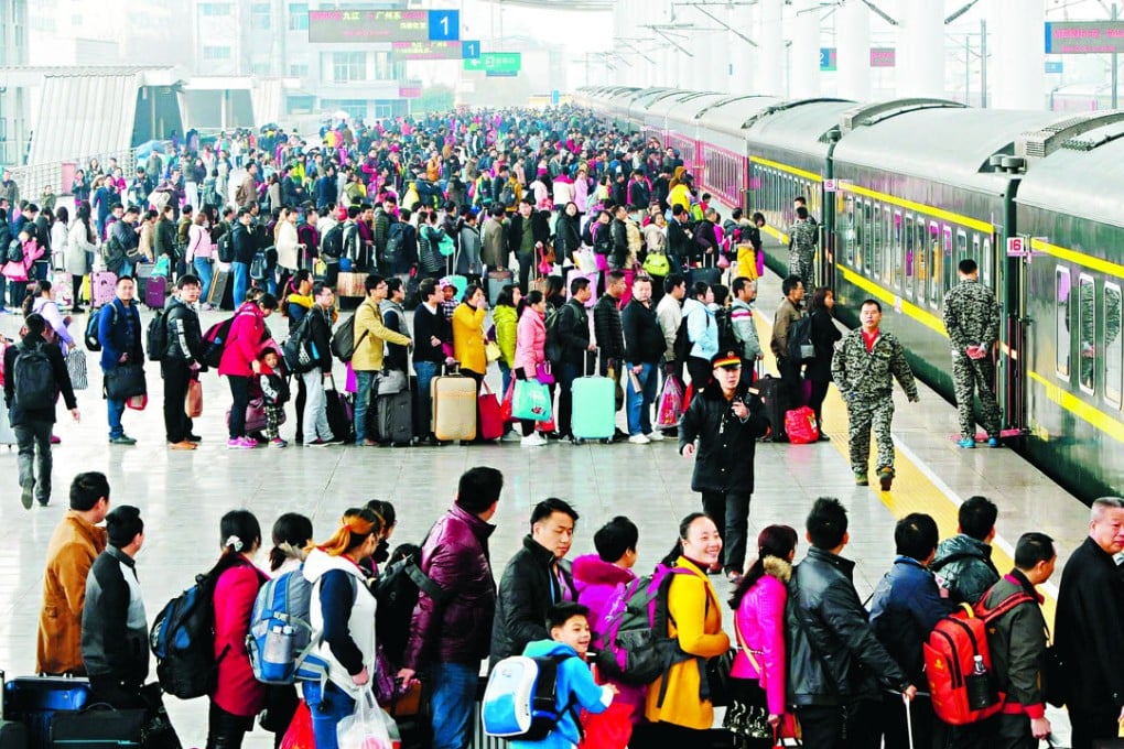 Passengers wait to board a train at a railway station during the Chinese Lunar New Year travel rush, in Jiujiang, Jiangxi province. Photo: Reuters
