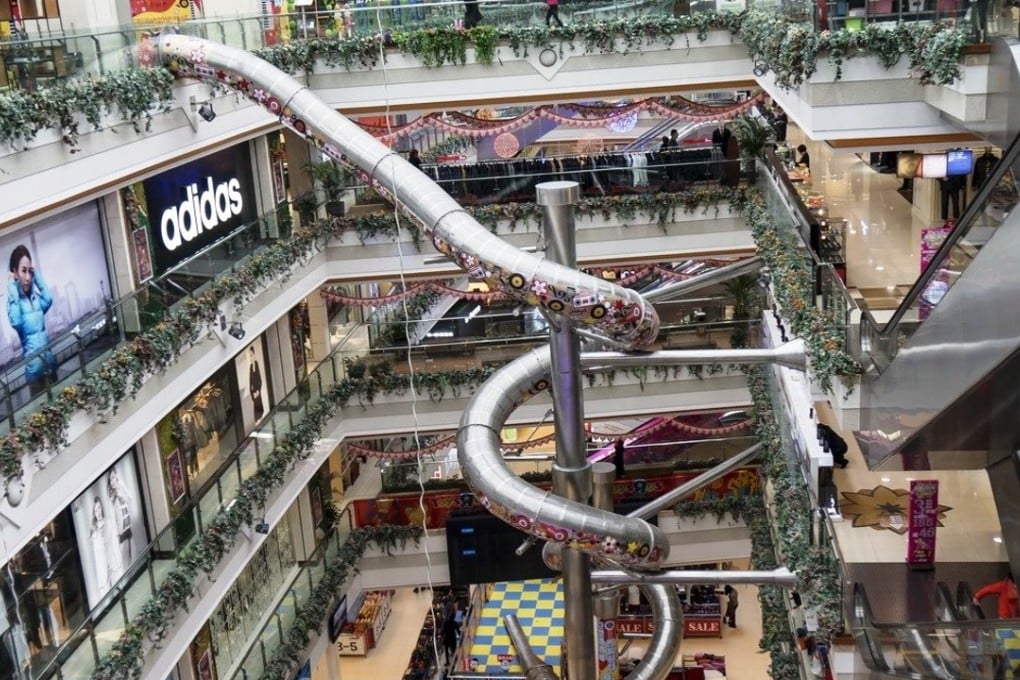 The enclosed slide wends its way down five floors of the Printemps Mall in Shanghai. Photo: SCMP Pictures