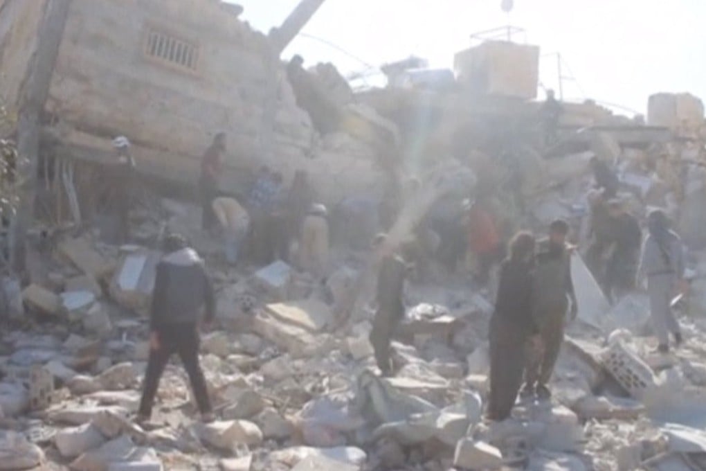 People gather near a destroyed building said to be a Medecins Sans Frontieres (MSF) supported hospital in Marat al Numan, Idlib, Syria. Photo: Reuters