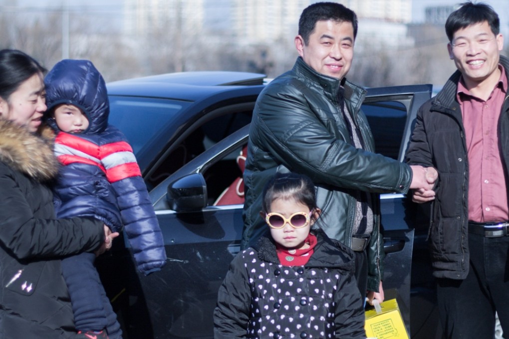 Carowner Zhao Licheng (right) says goodbye to a family he drove with from Beijing to Baoding in Hebei province. Photo: SCMP Pictures