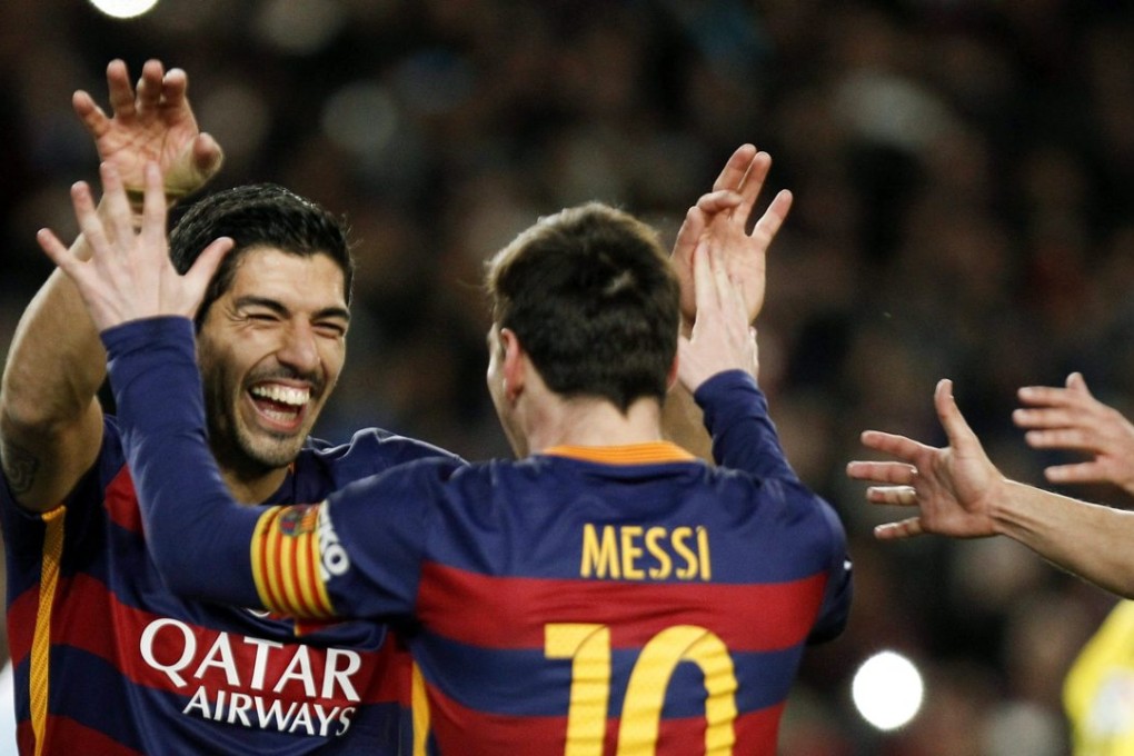 Luis Suarez celebrates with Leo Messi. Photo: EPA