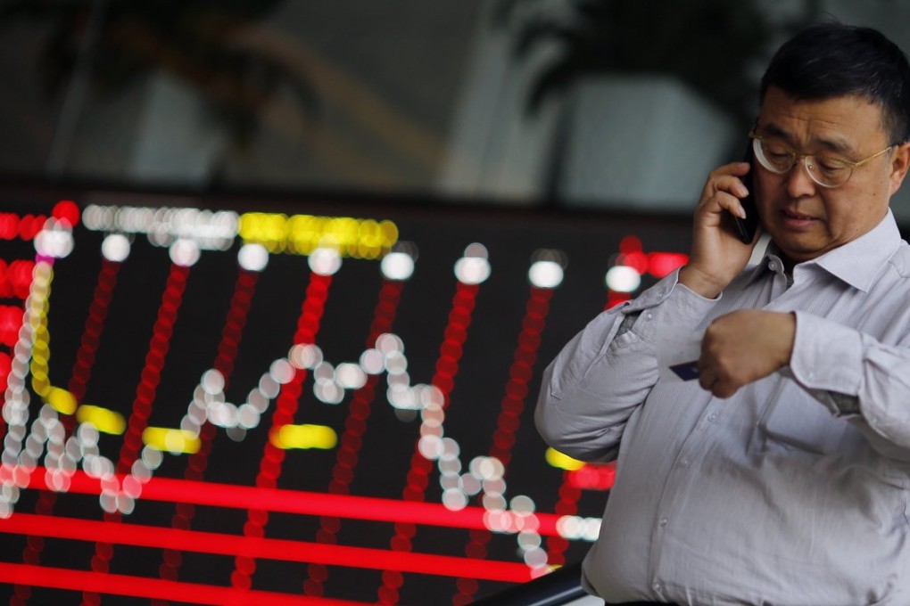 A man talks on the phone inside the Shanghai Stock Exchange building at the Pudong financial district in Shanghai as markets in China reopen after being closed from February 5 for the Lunar New Year. Photo: Reuters