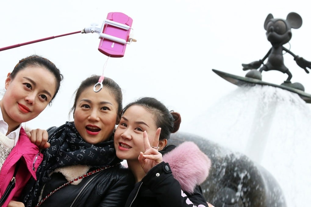 Visitors take a picture at Hong Kong Disneyland. Photo: Dickson Lee